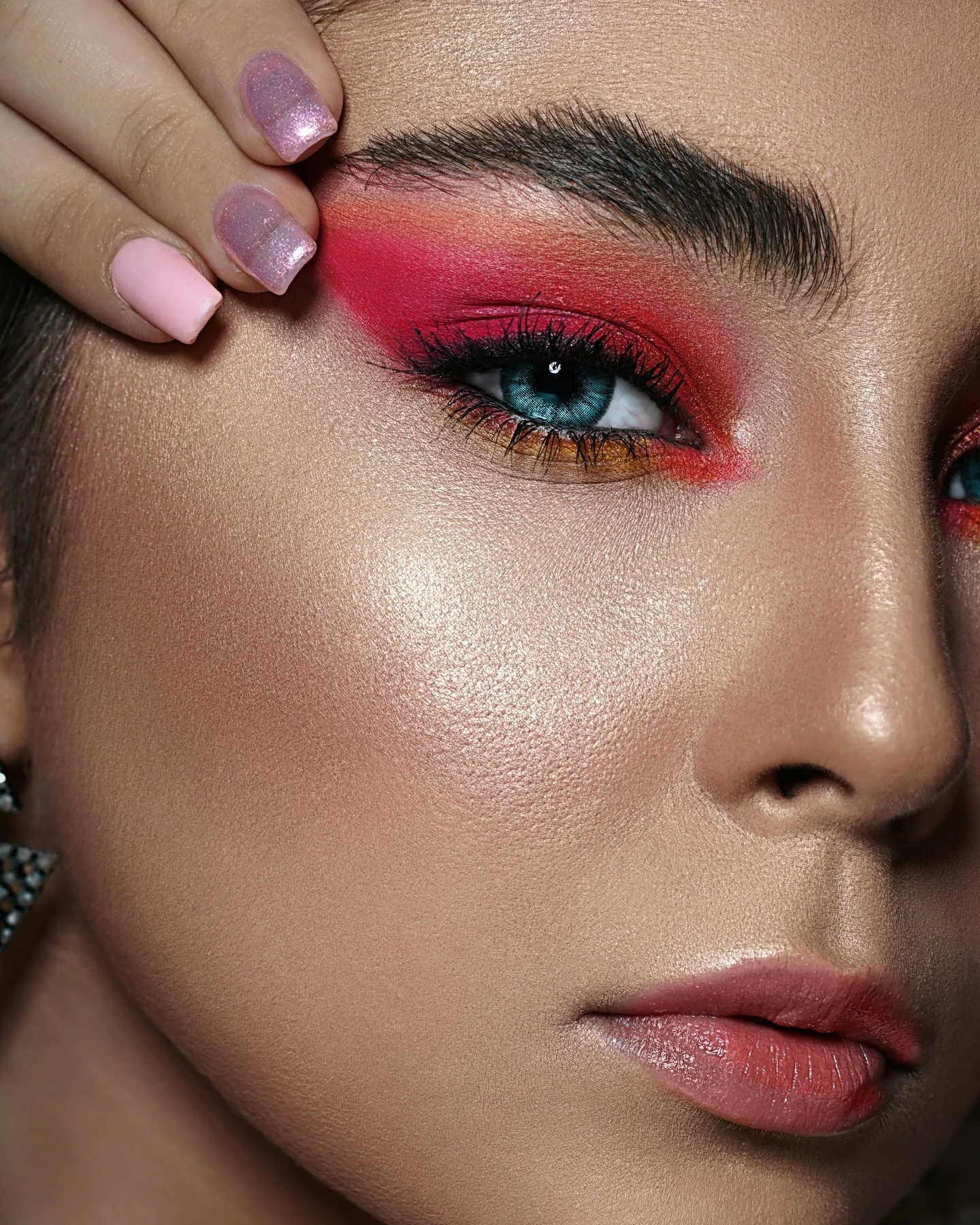Bold editorial eye makeup in pink and red tones